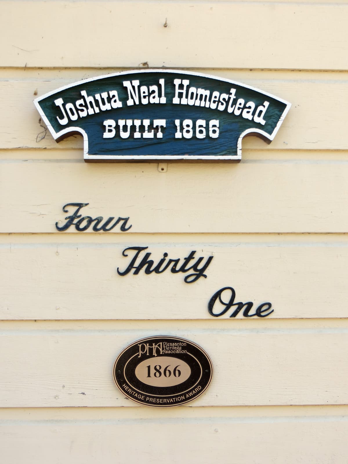 A bronze heritage plaque mounted on the historic Joshua Neal Rancho